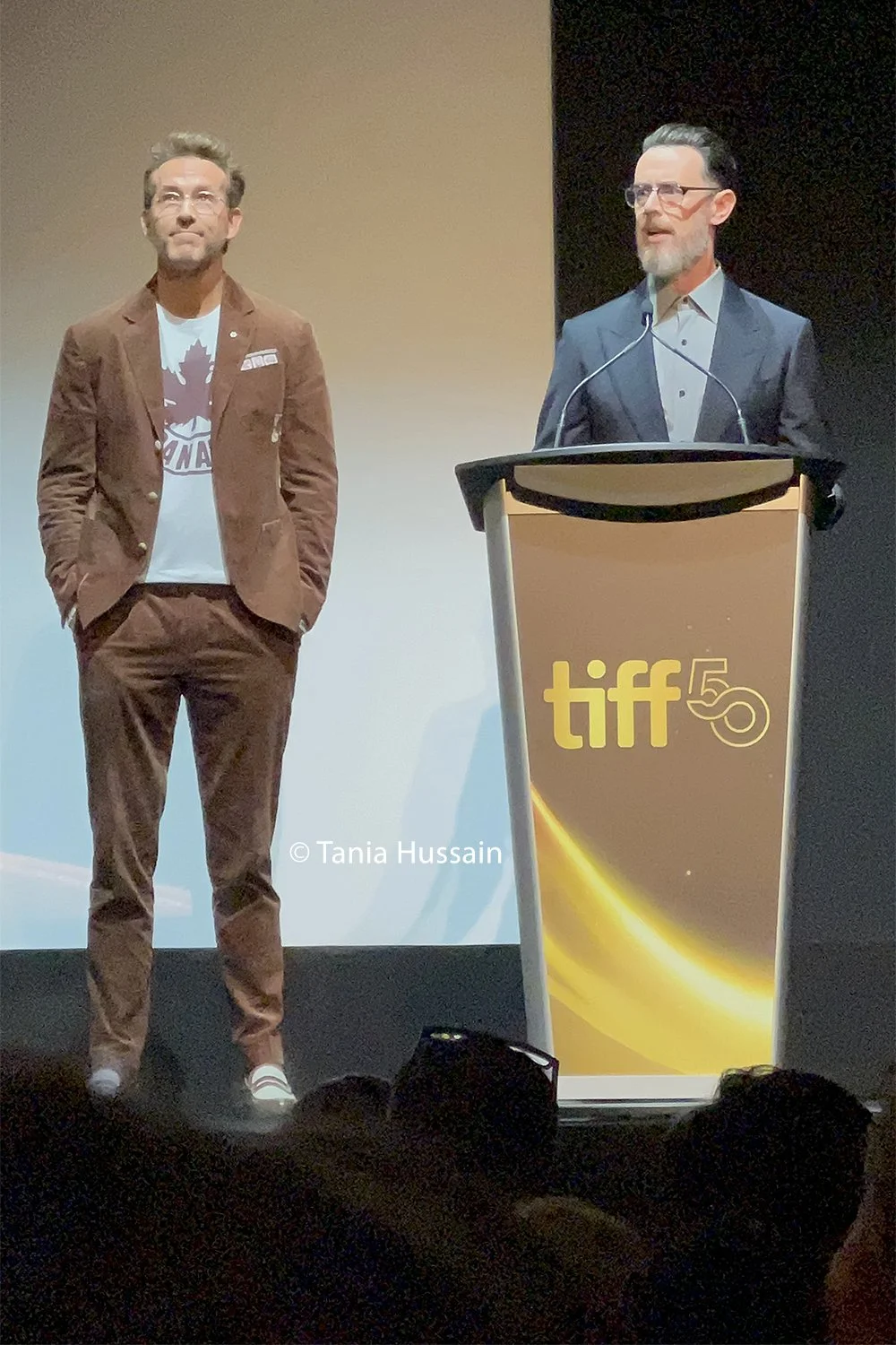 Ryan Reynolds and Colin Hanks speaking at the premiere of 'John Candy: I Like Me' at the Princess of Wales Theatre on Sept. 6, 2025.