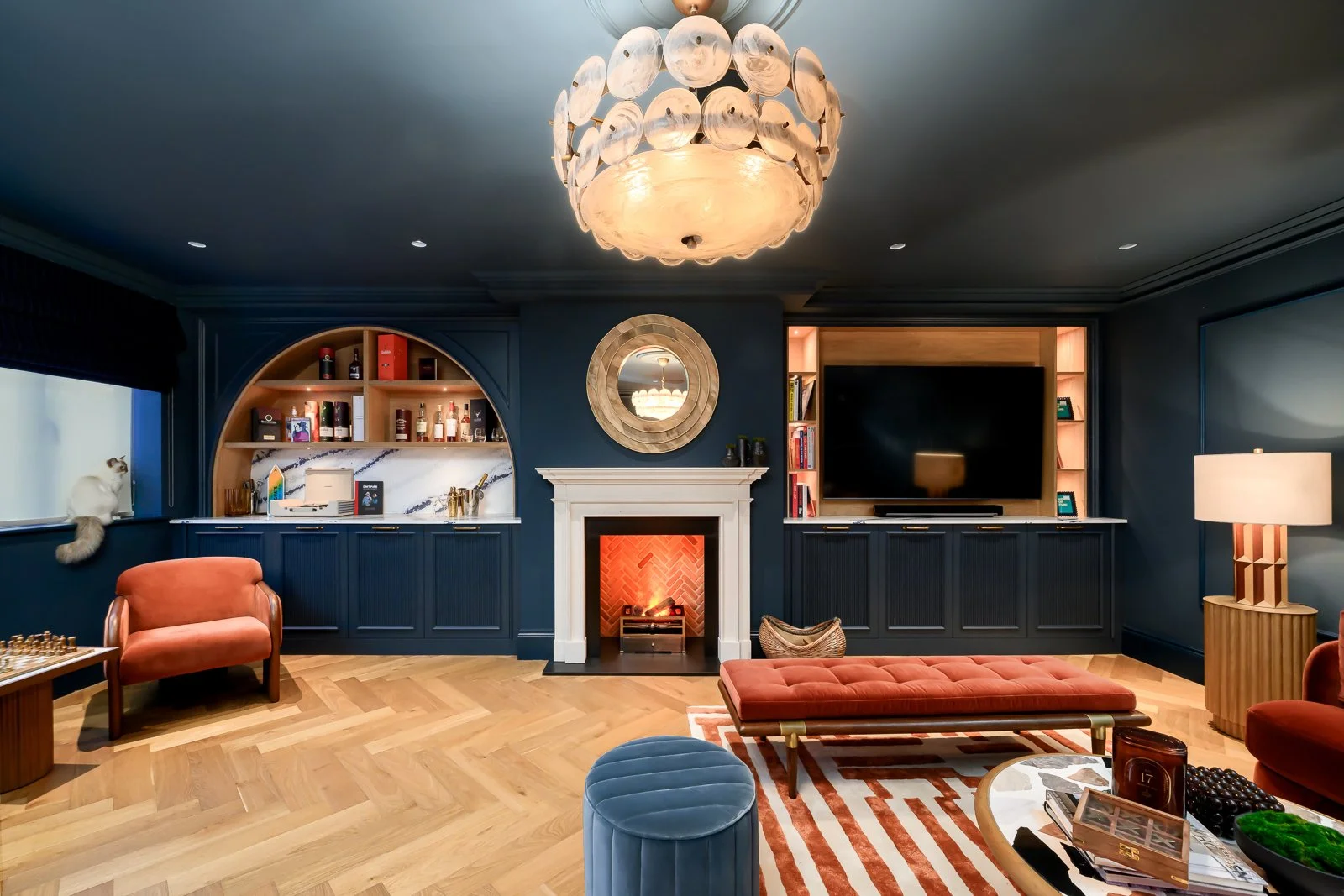 Dark lounge interior at Newlands by Rebecca Sudic Interiors, photographed to show colour, atmosphere, furniture, lighting and lived-in detail.