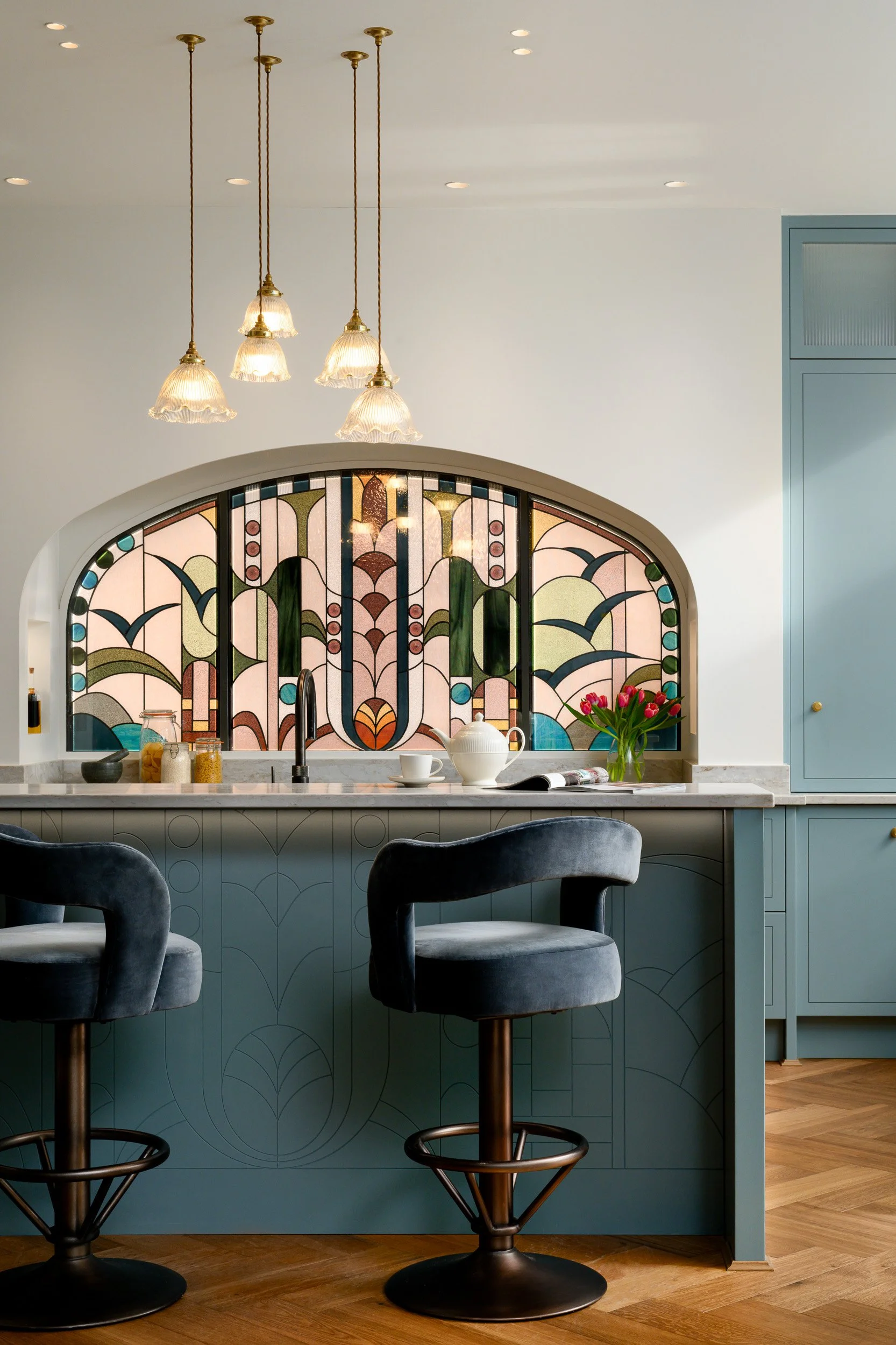Luxury blue kitchen with stained glass photographed by London interior photographer Alicja Korbinska