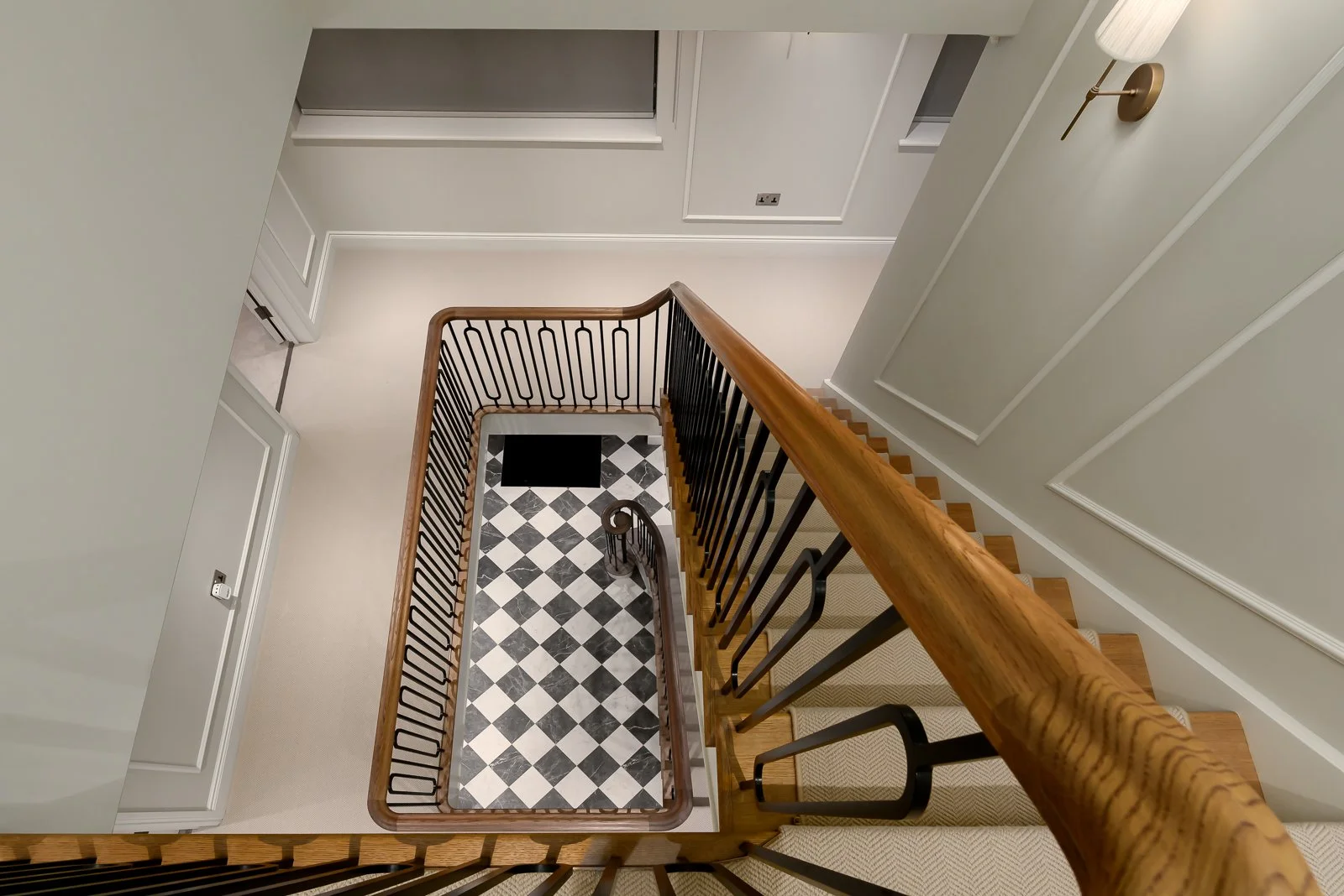 Hallway and staircase detail at Newlands by Rebecca Sudic Interiors, showing patterned flooring, bespoke joinery and the home’s architectural character.