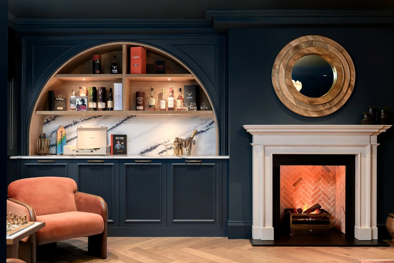 Dark lounge interior at Newlands by Rebecca Sudic Interiors, photographed to show colour, atmosphere, furniture, lighting and lived-in detail.