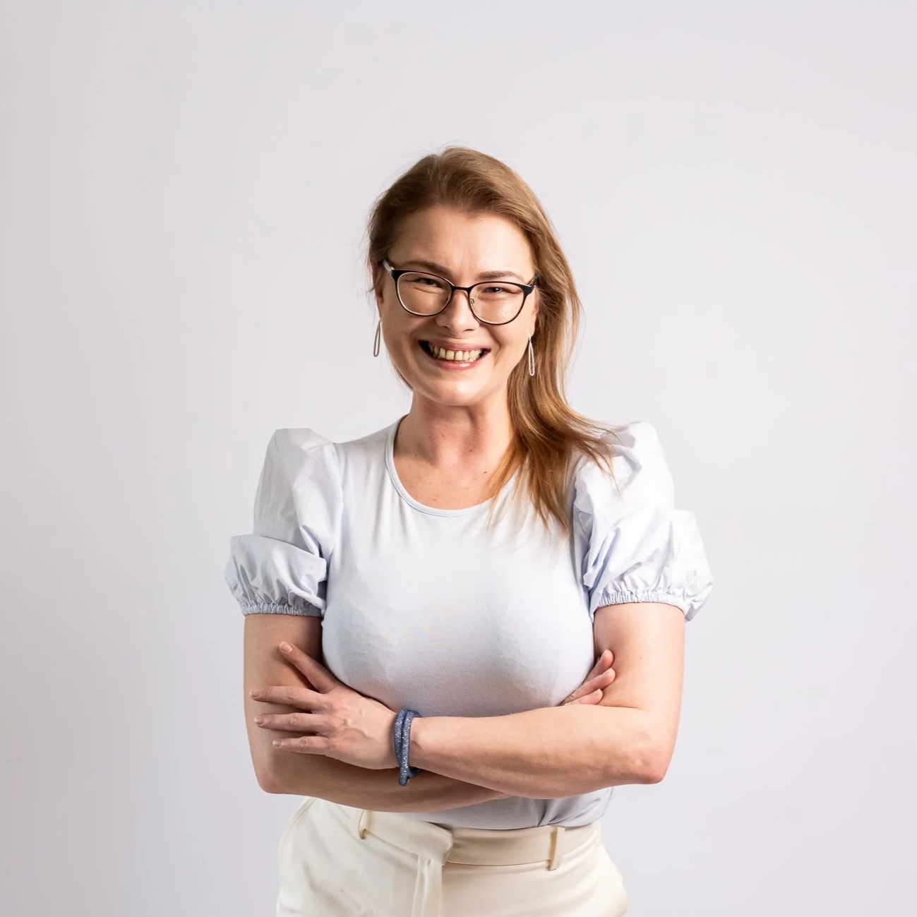 Official headshot of a woman smiling, looking approachable and professional.
