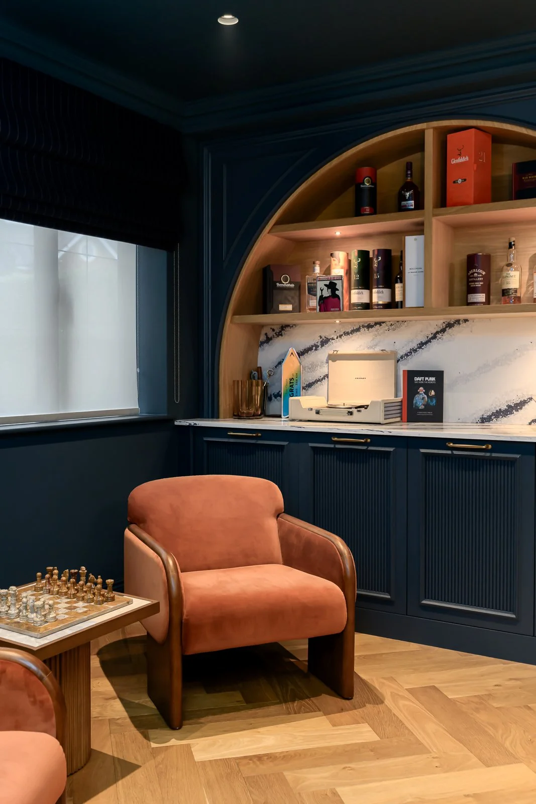Dark lounge interior at Newlands by Rebecca Sudic Interiors, photographed to show colour, atmosphere, furniture, lighting and lived-in detail.