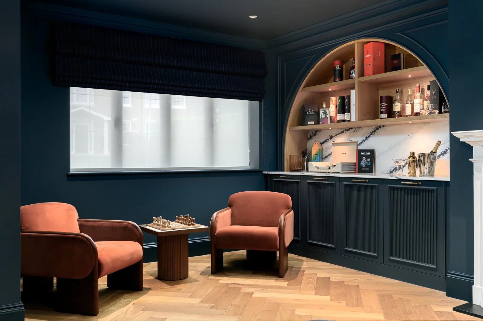 Dark lounge interior at Newlands by Rebecca Sudic Interiors, photographed to show colour, atmosphere, furniture, lighting and lived-in detail.