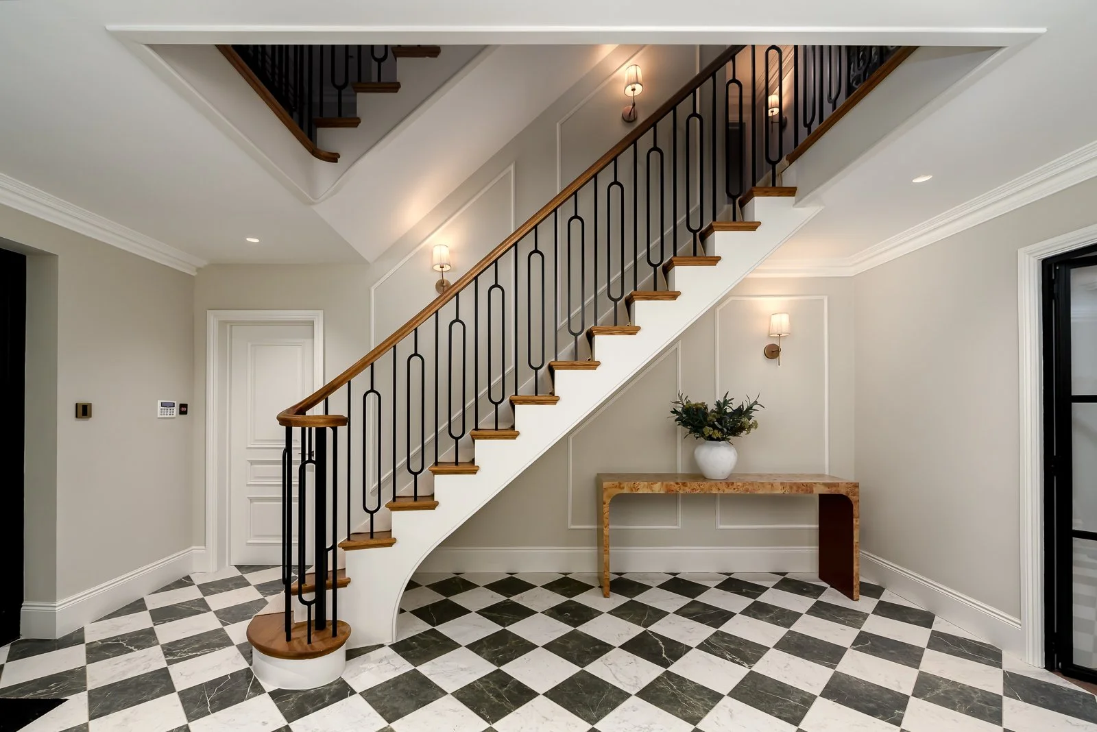 Hallway and staircase detail at Newlands by Rebecca Sudic Interiors, showing patterned flooring, bespoke joinery and the home’s architectural character.