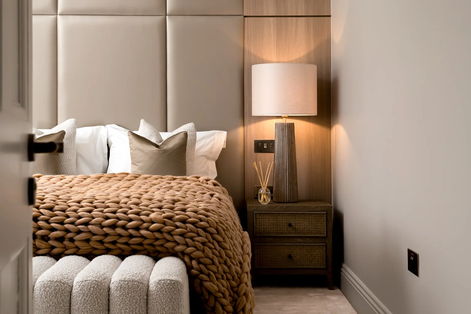 Luxury bedroom interior in Hampstead, London, with soft lighting, woven throw and designer bedside details — highlighting the privacy and legal consent considerations in residential interior photography.