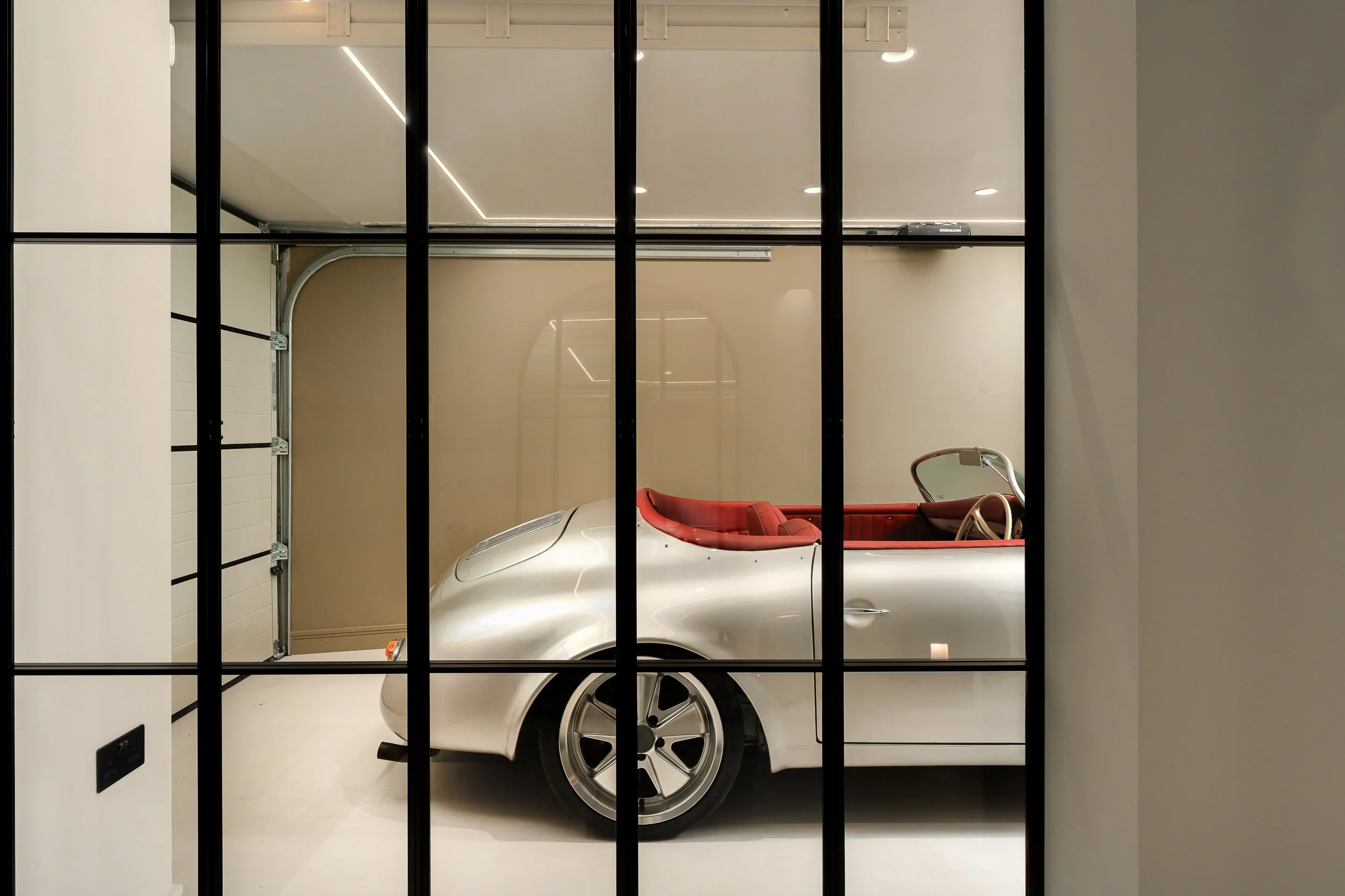 Architectural photography of black-framed internal glazing, doors and windows in a contemporary London residential interior.
