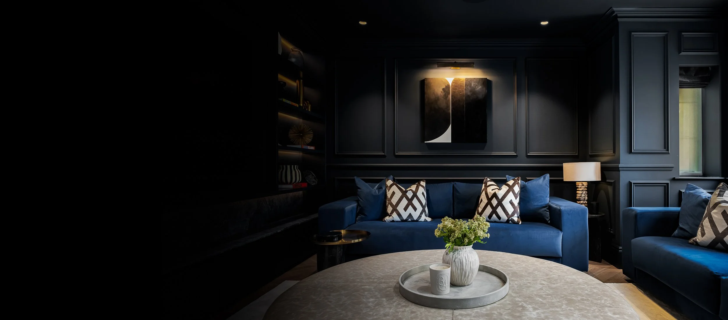 Luxury interior architecture photograph of a refined London living space with bespoke furnishings, architectural glazing and layered lighting.
