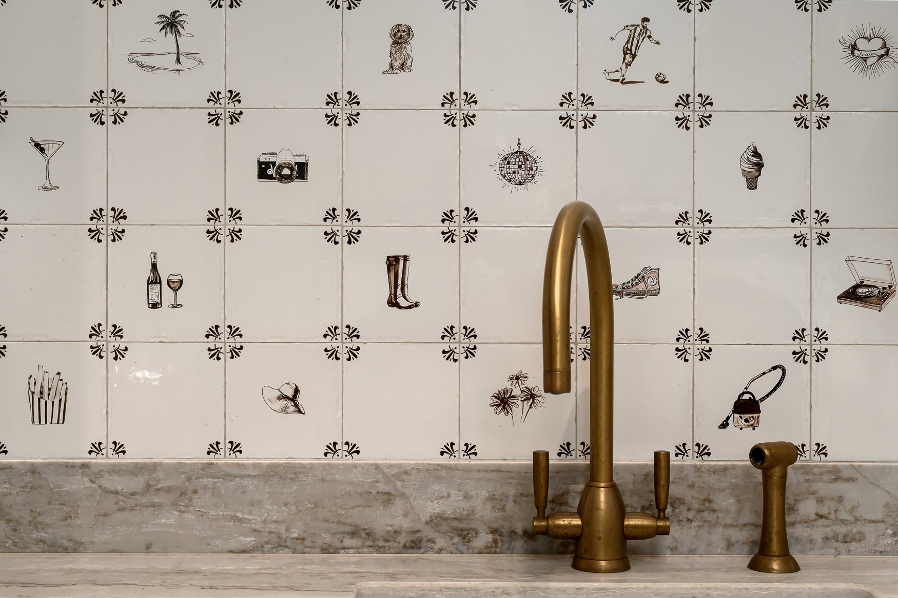 Close-up of handmade illustrated tiles designed to represent the family’s hobbies and personality.