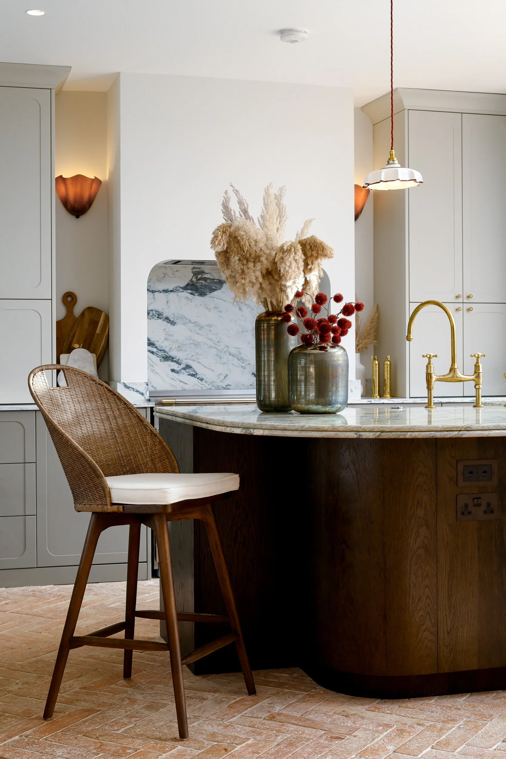 CLoser view of the kitchen with bar chairs and rounded island