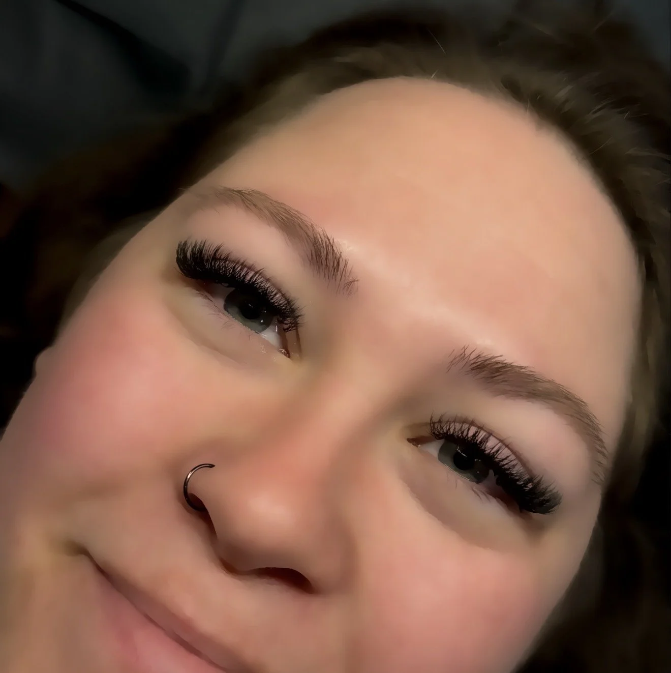 Hybrid lash extensions combining classic and volume fans for a textured, soft glam finish