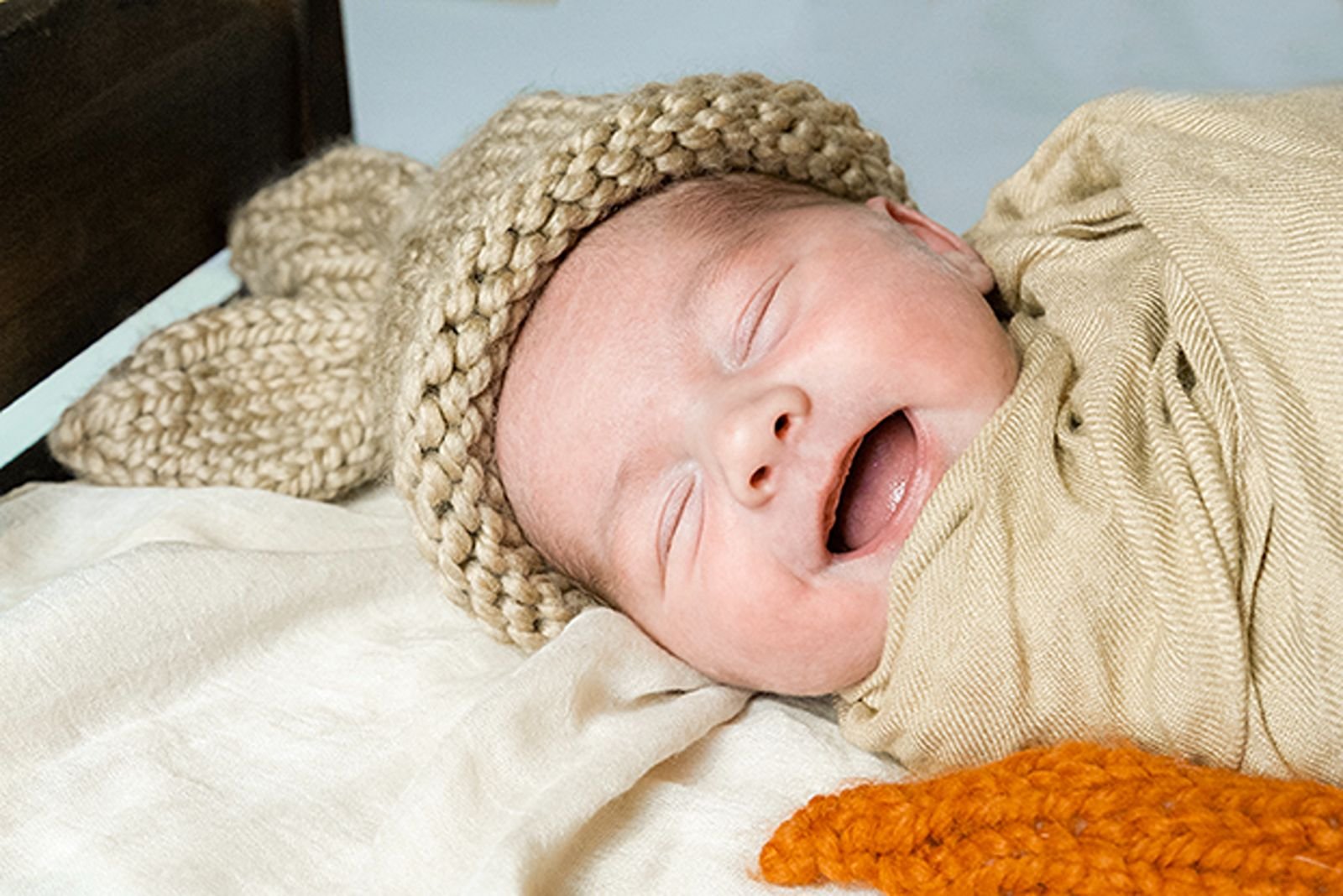 newborn photo of baby boy smiling