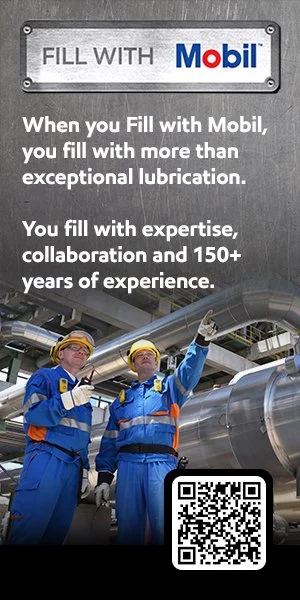 Two industrial workers in blue uniforms and yellow safety helmets, pointing upwards, in an industrial setting with metallic pipes, next to a Mobil sign promoting lubrication expertise and collaboration.