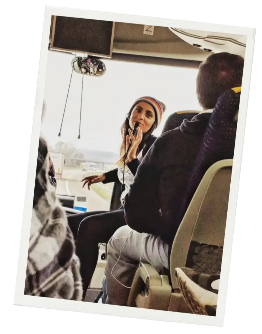 jude douglass talks to tourists on a bus