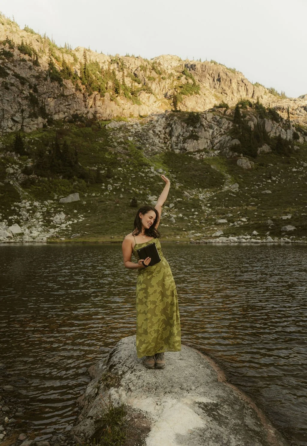 Jude Douglass cheers by the lake after an elopement ceremony