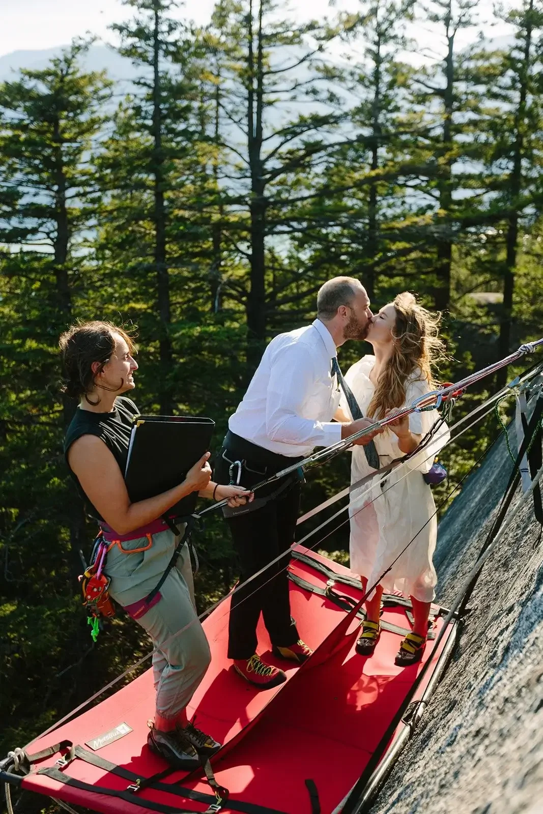 jude marries bride and groom on side of a cliff in a climbing elopement