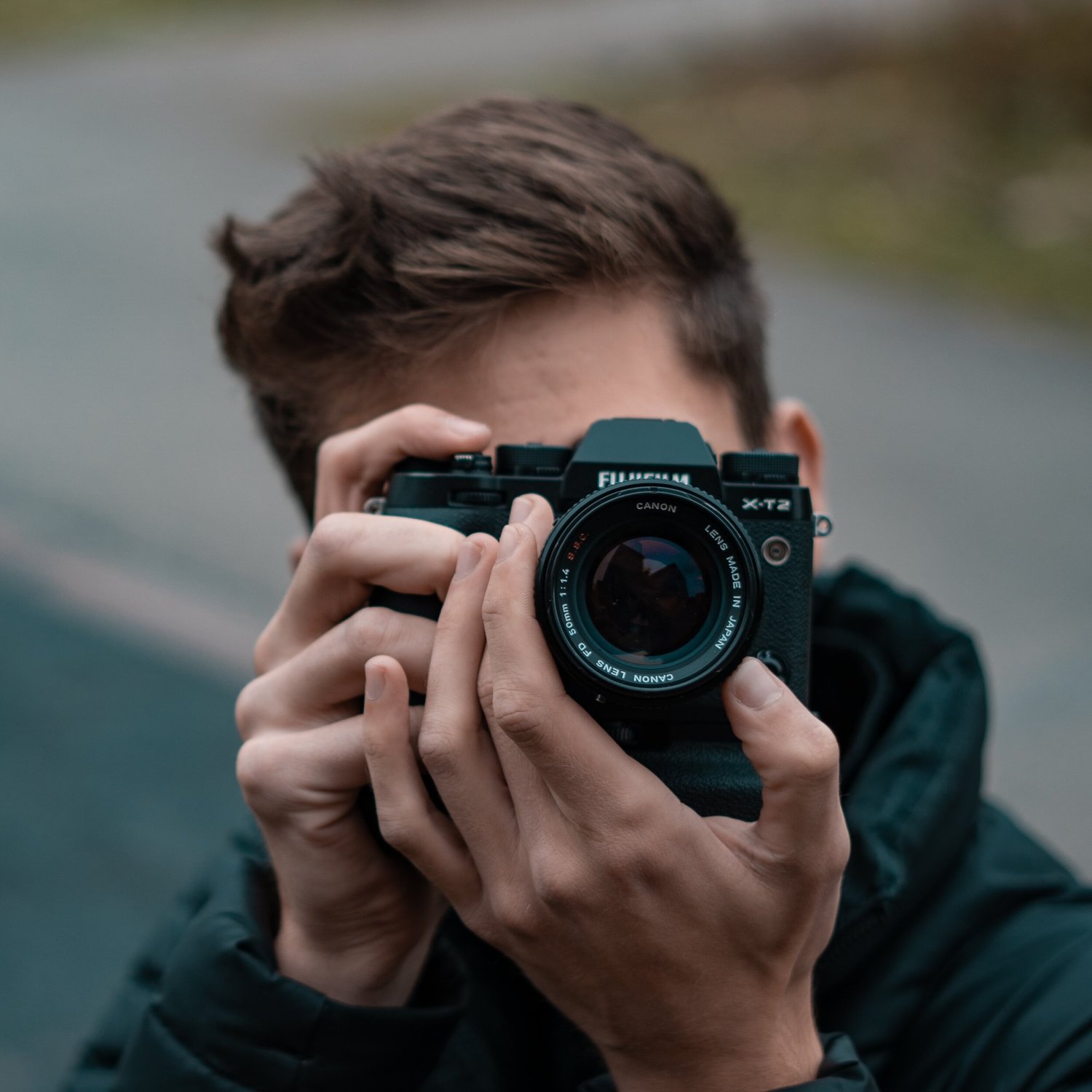 A photographer raising a camera to his eye