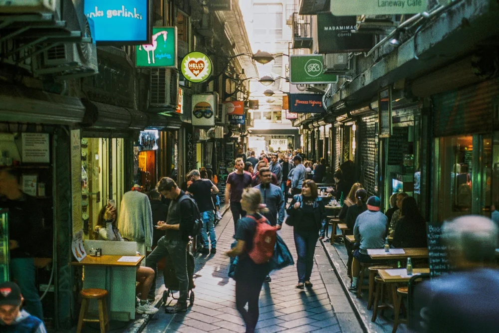 A busy Melbourne laneway with cafés and people walking