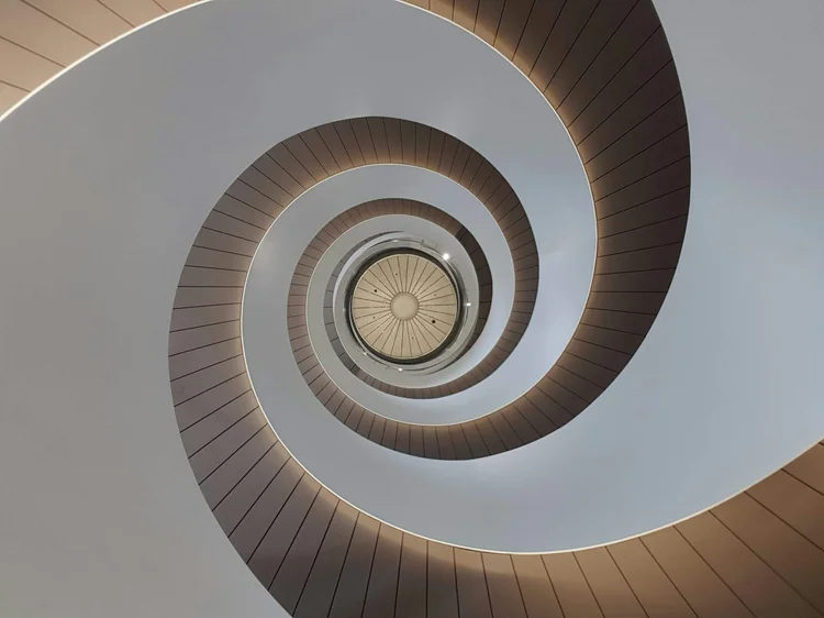 A spiral staircase photographed from below