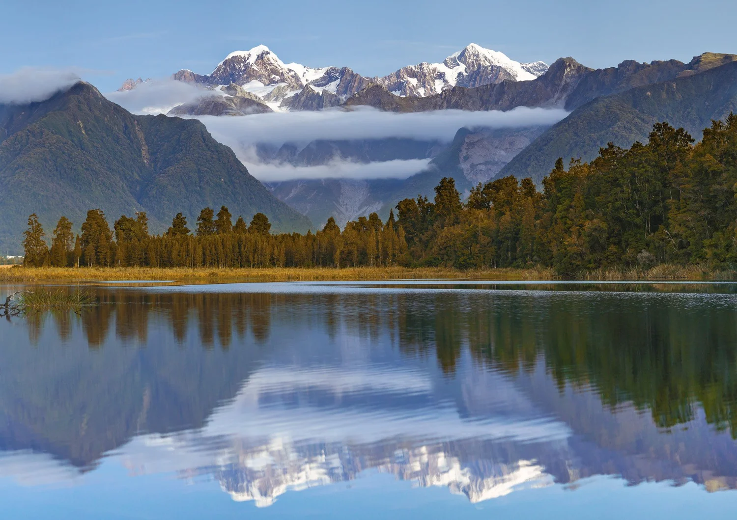 Snow-capped mountains reflected in a lake