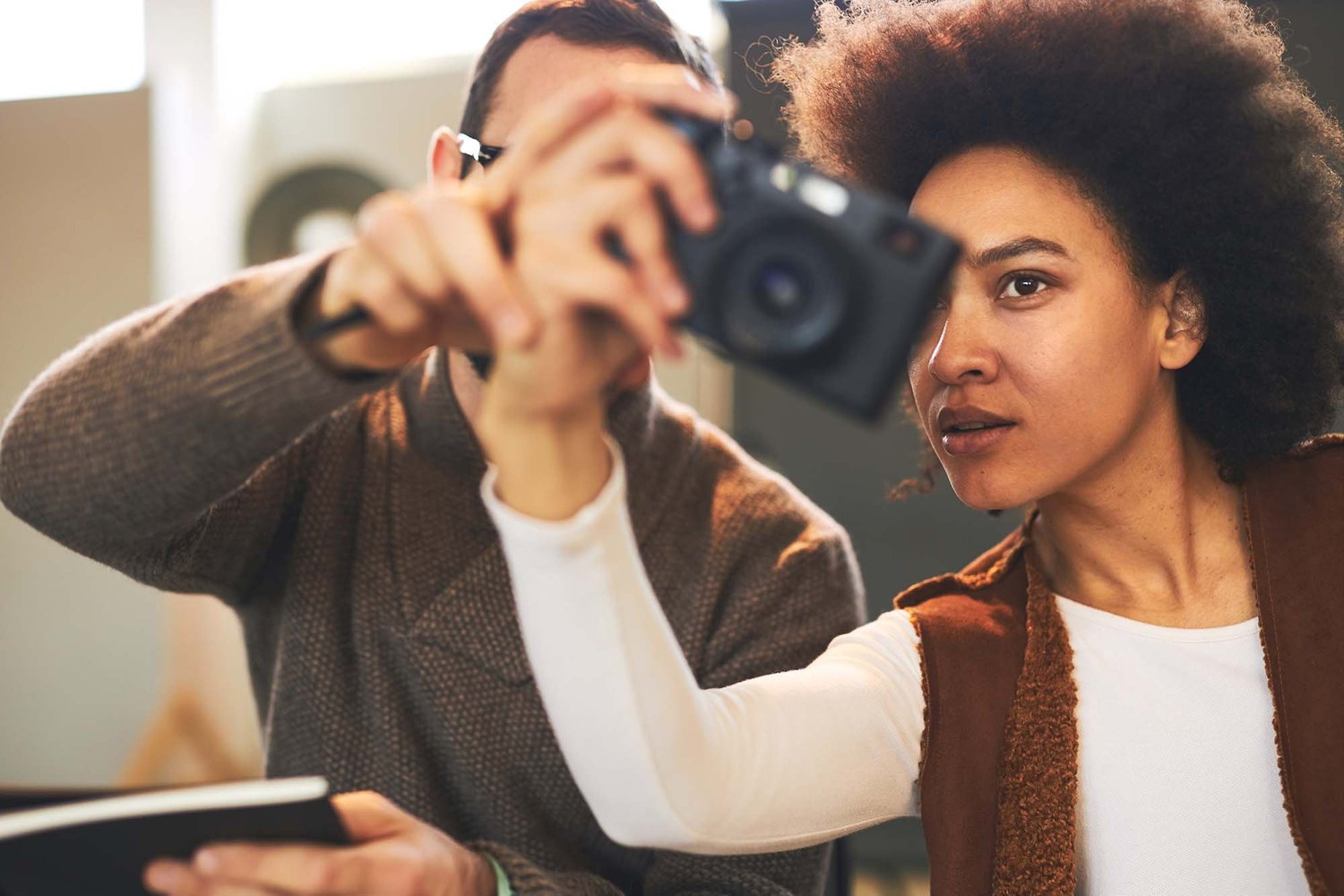 A photographer checking her camera settings during a workshop