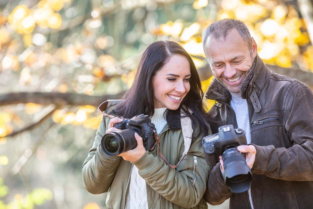 Two friends photographing together outdoors