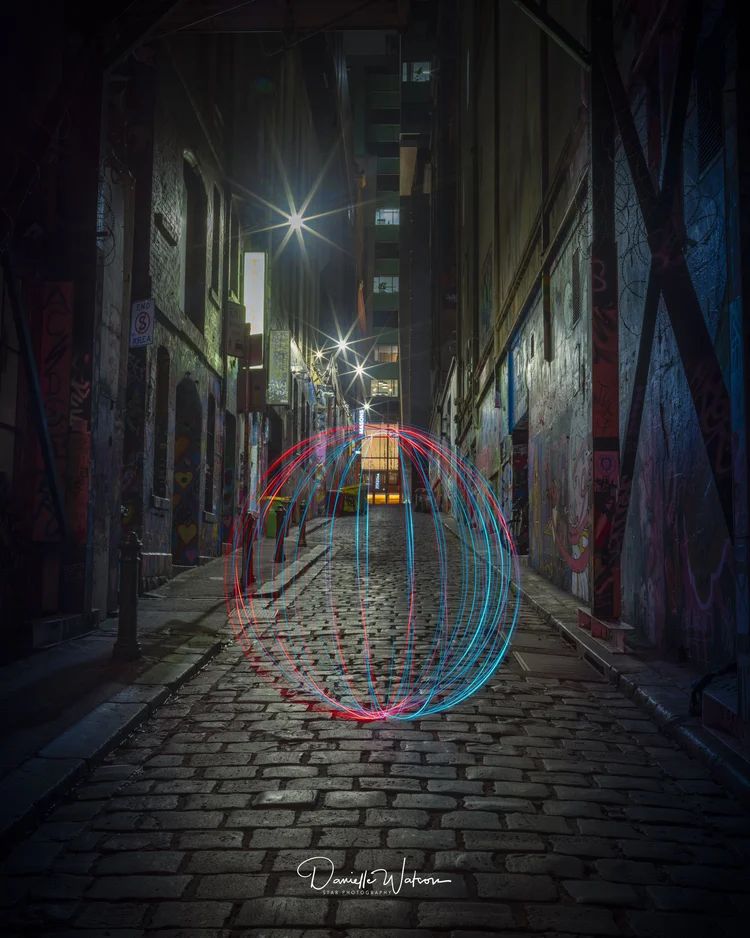 A glowing light-painted orb in a Melbourne laneway at night