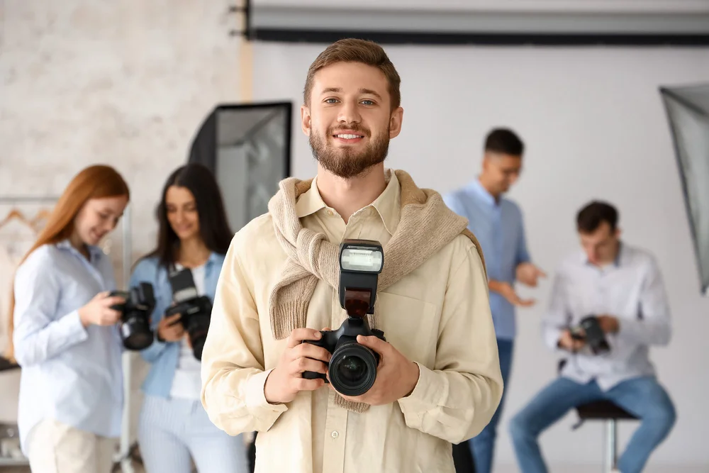 An educator showing a small group how to use their cameras