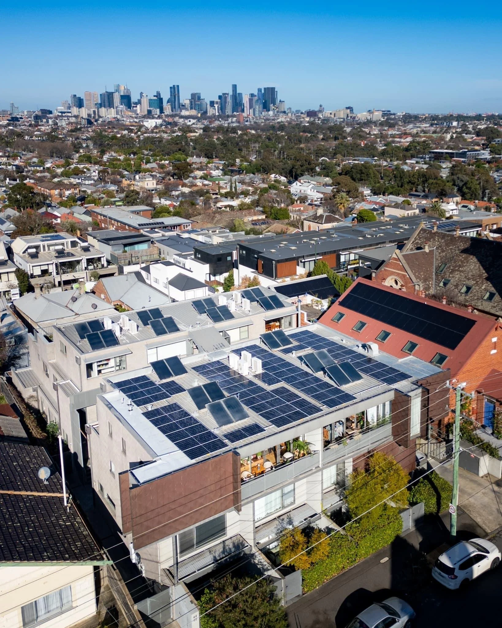 Solar PV on the roof of an apartment building, with the Melbourne CBD in the background