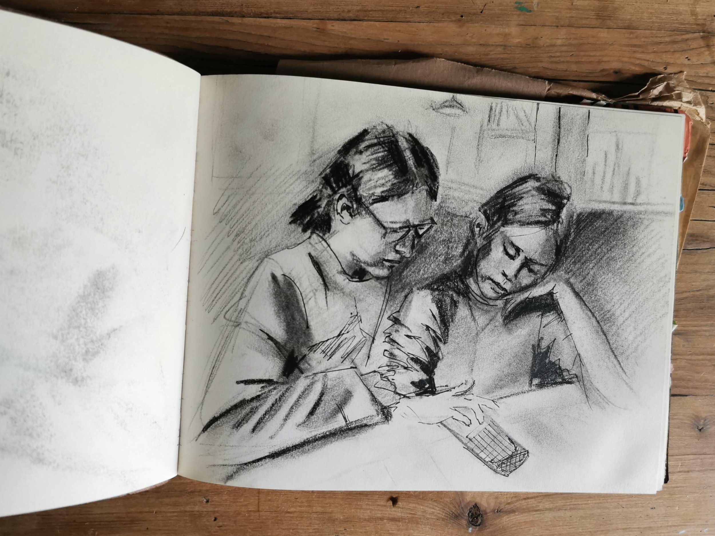 sketchbook page open to drawing of two girls.jpg