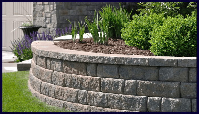 Curved brick retaining wall with garden bed and manicured landscaping in Albury-Wodonga