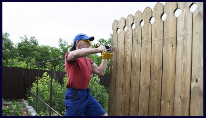 Fencing contractor in Albury NSW installing a timber fence with power tools for quality results
