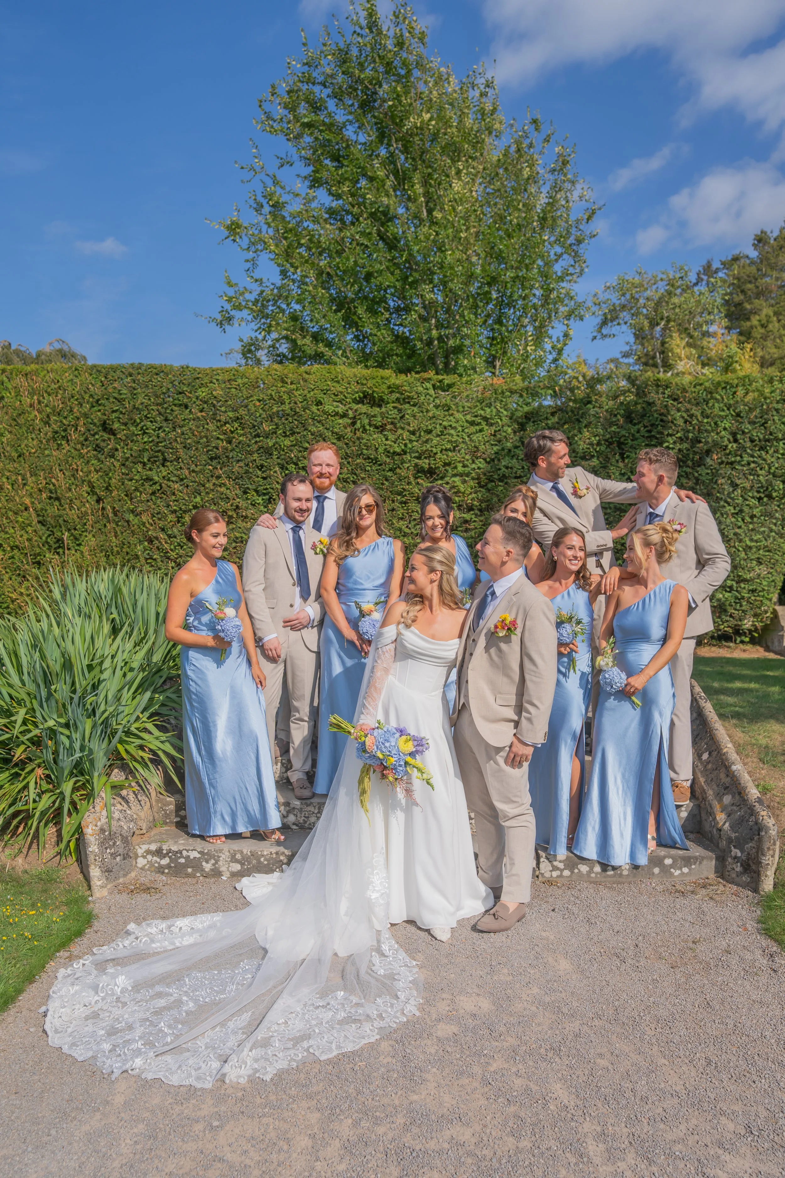Bridal party celebrating together outside Tortworth Court.jpg