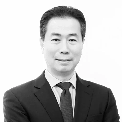 Black and white portrait of a man in a suit smiling