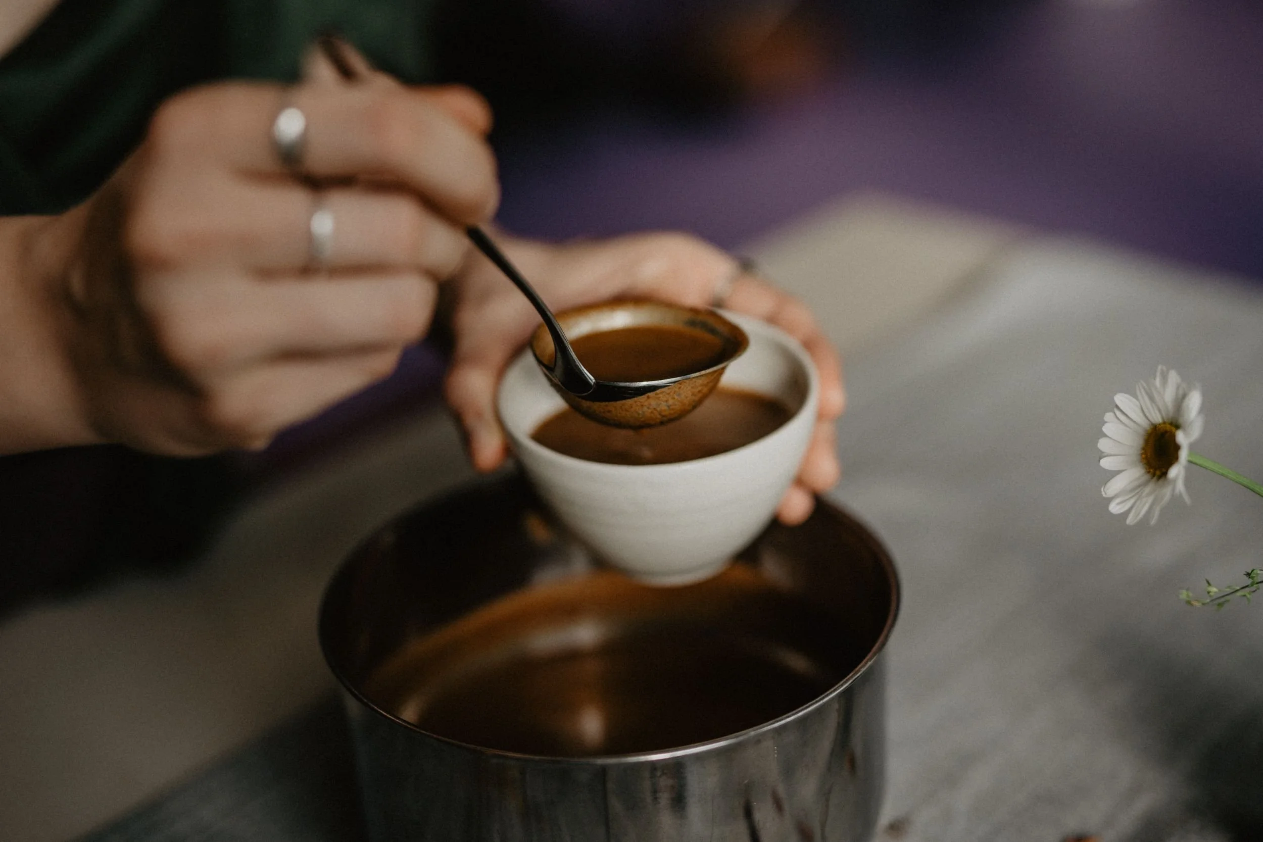Zeremonieller Kakao wird bei einem Cacao Circle in eine Tasse eingeschenkt.