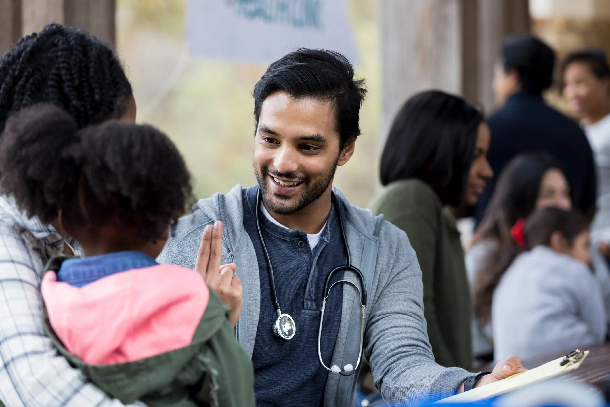 Doctor checks patient at outdoor free clinic