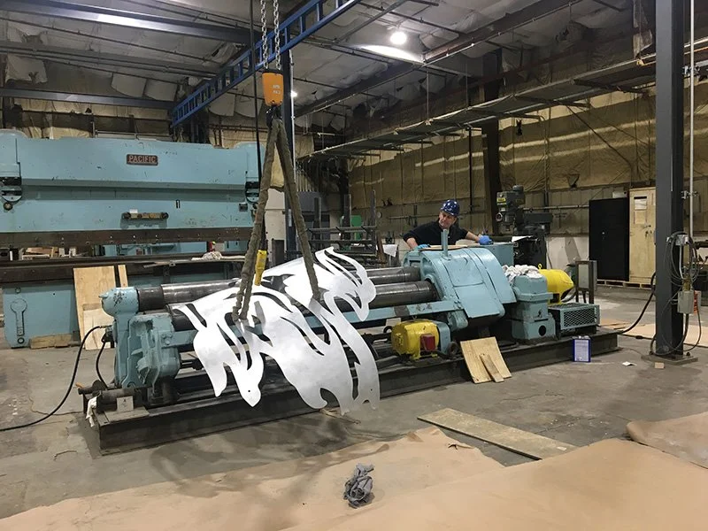 Watch Mike go! Here he is rolling the aluminum pieces so they exactly match the curves in my model.