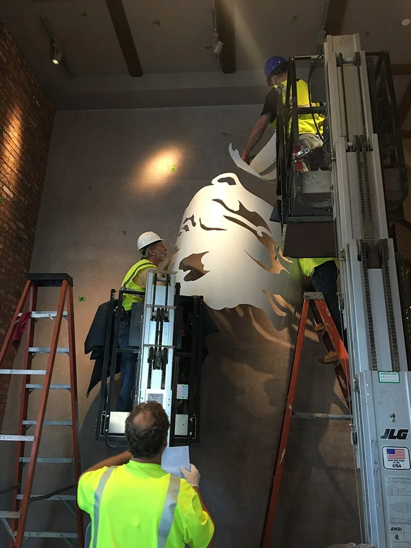 After much measuring, lifting, unwrapping and preparation, the first pieces go up in a very specific order.