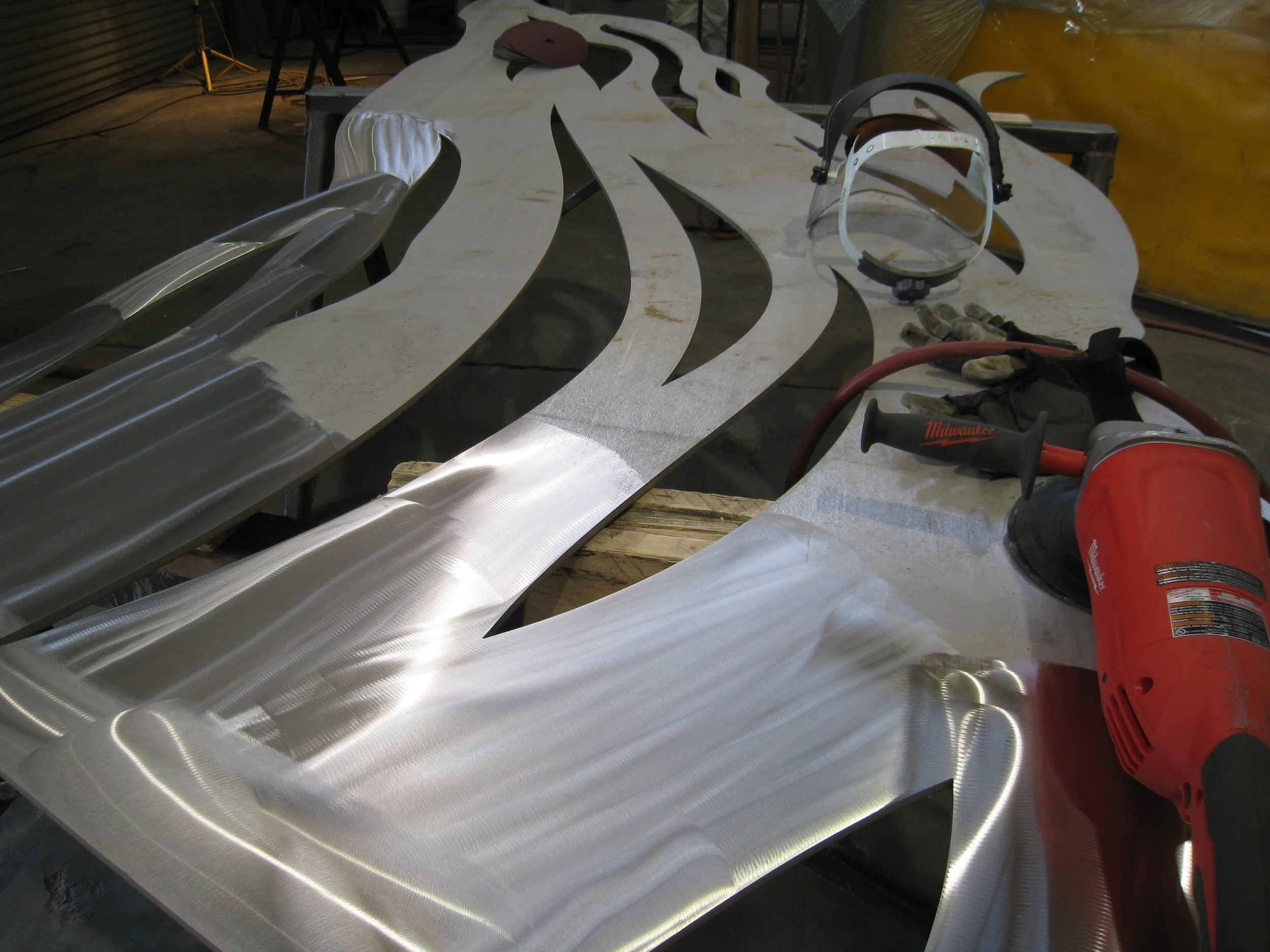 Each piece needs to be finished before it's rolled to get rid of the rough surface. That process is called "skinning." This piece had the holes open before rolling, unlike the one pictured above.