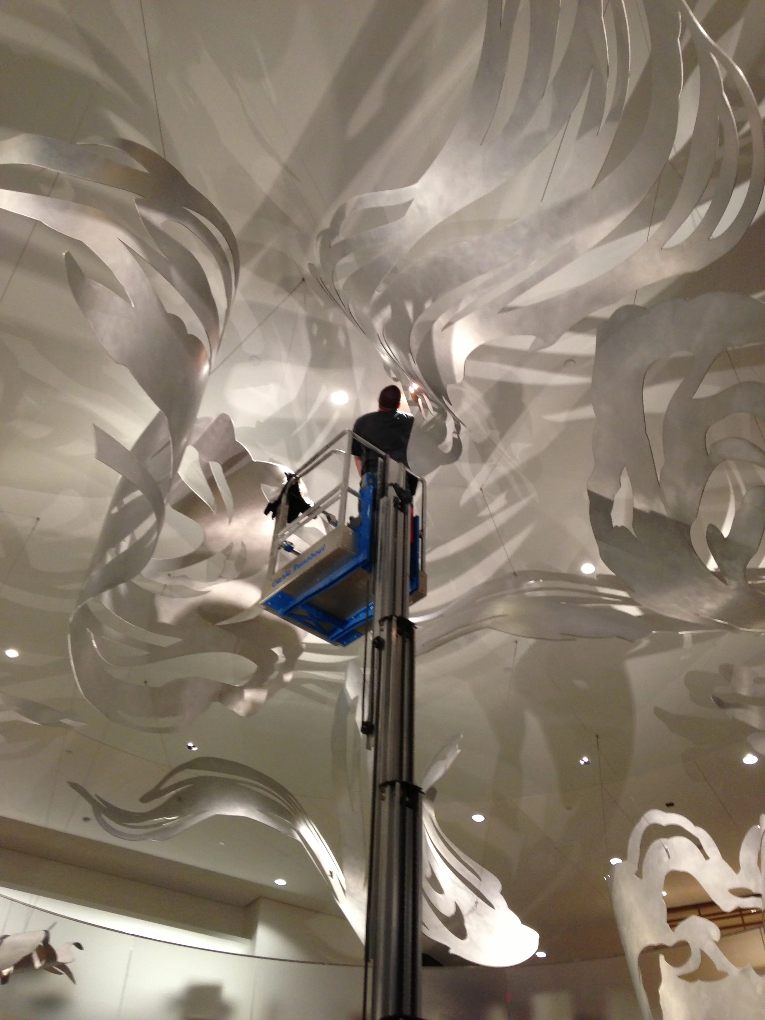 An electrician positions the ceiling lights for me and the lighting team from Lam Partners and CBT at night. Many, many, many nights...