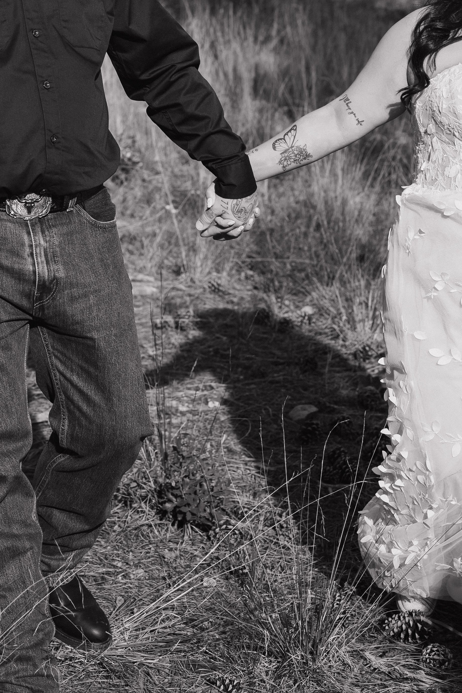 close up detail photo of a bride and groom holding hands after their wedding ceremony in arizona