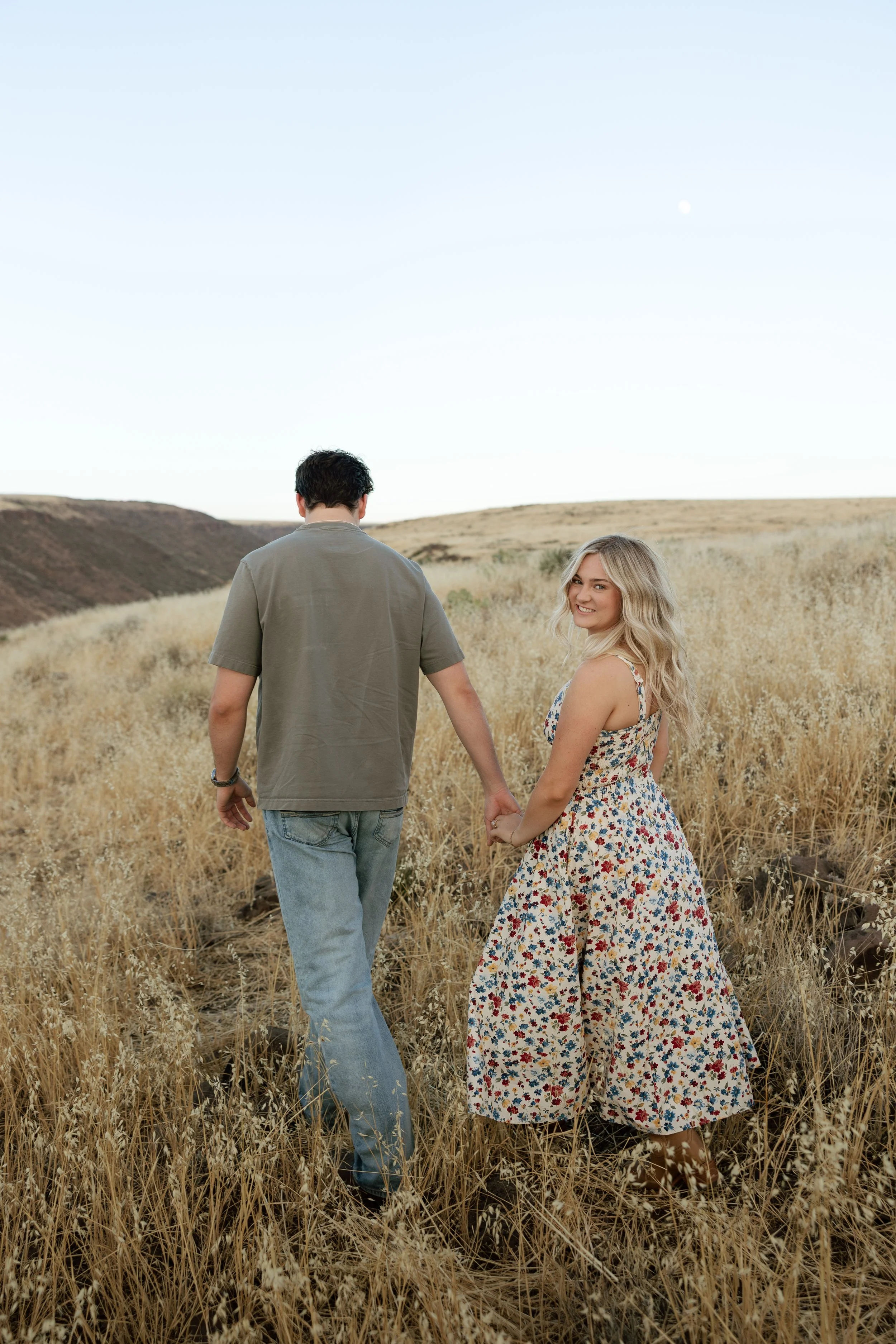 Candid engagement photo of a couple overlooking desert hills in Arizona