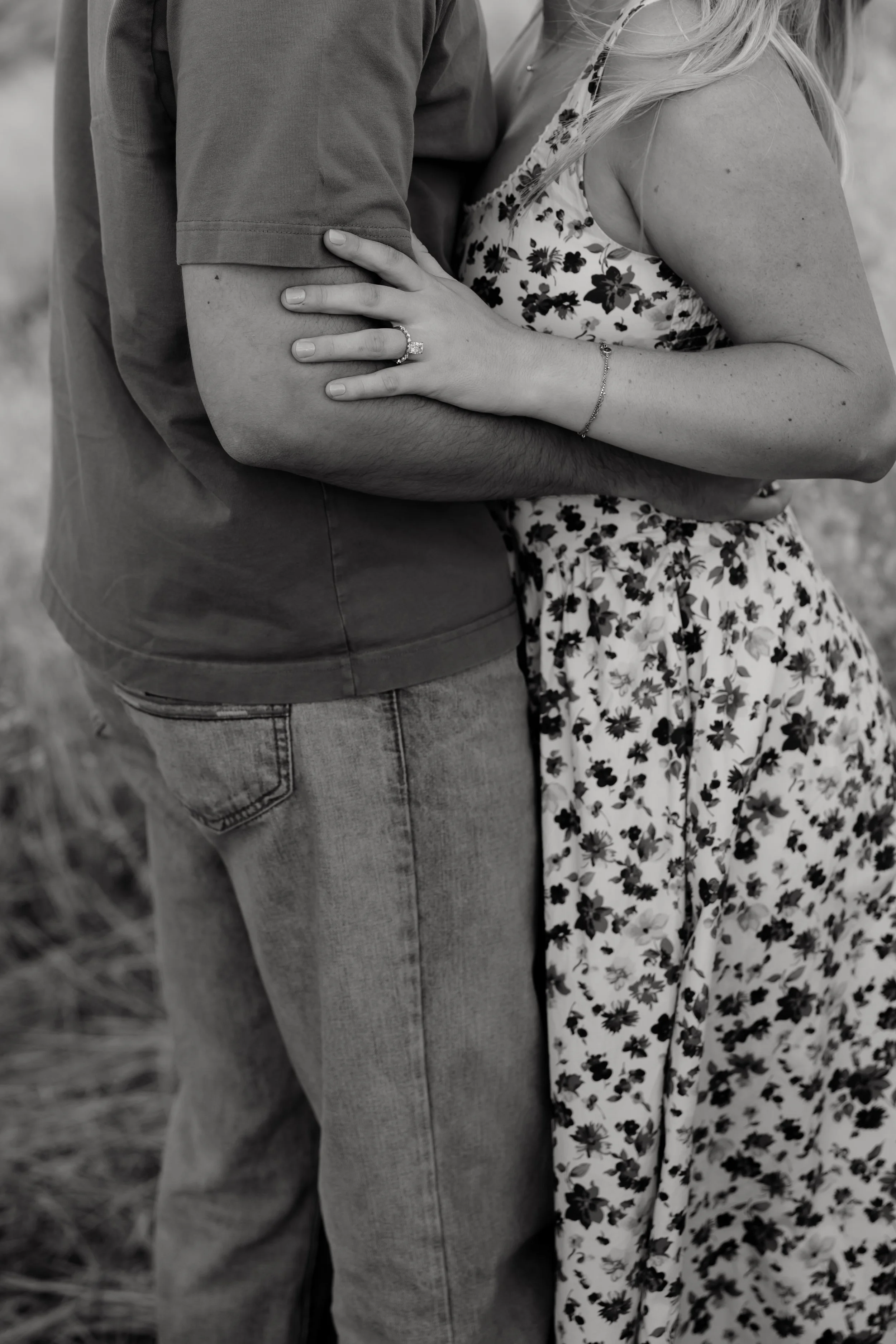 Couple embracing during a sunset engagement session in the desert hills of Arizona