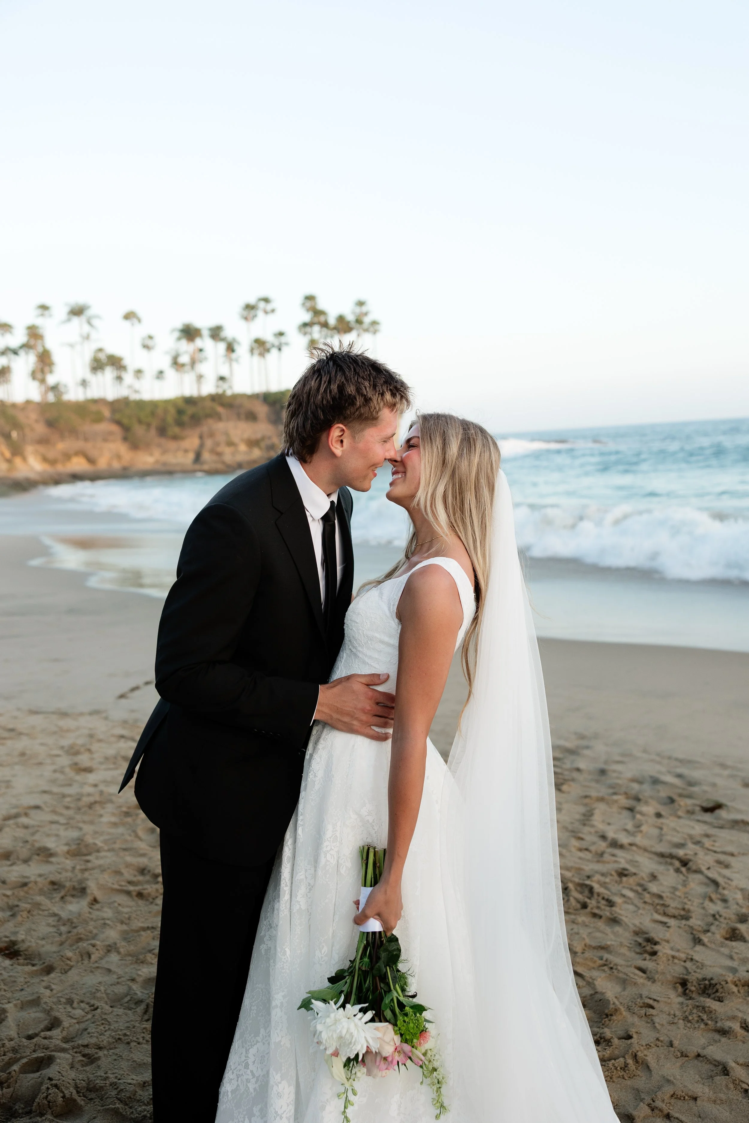 newlyweds share a kiss during their bridal portraits with a southern california wedding photographer