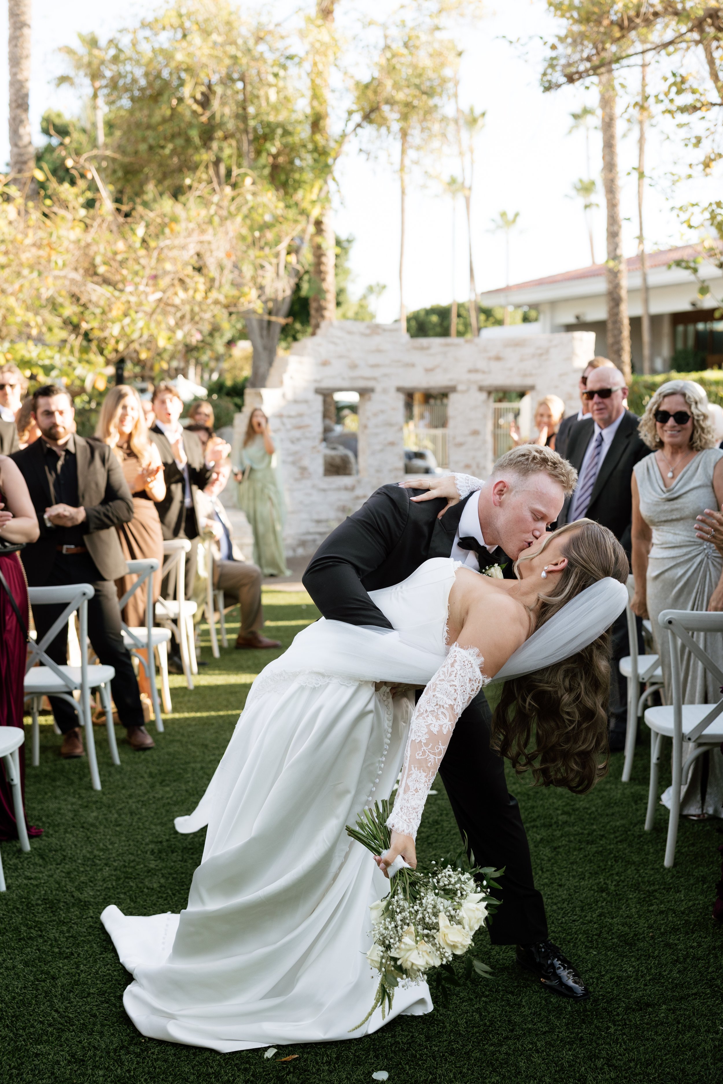 Bride and groom sharing a kiss during their ceremony recessional at The Scott Resort & Spa in Scottsdale, Arizona