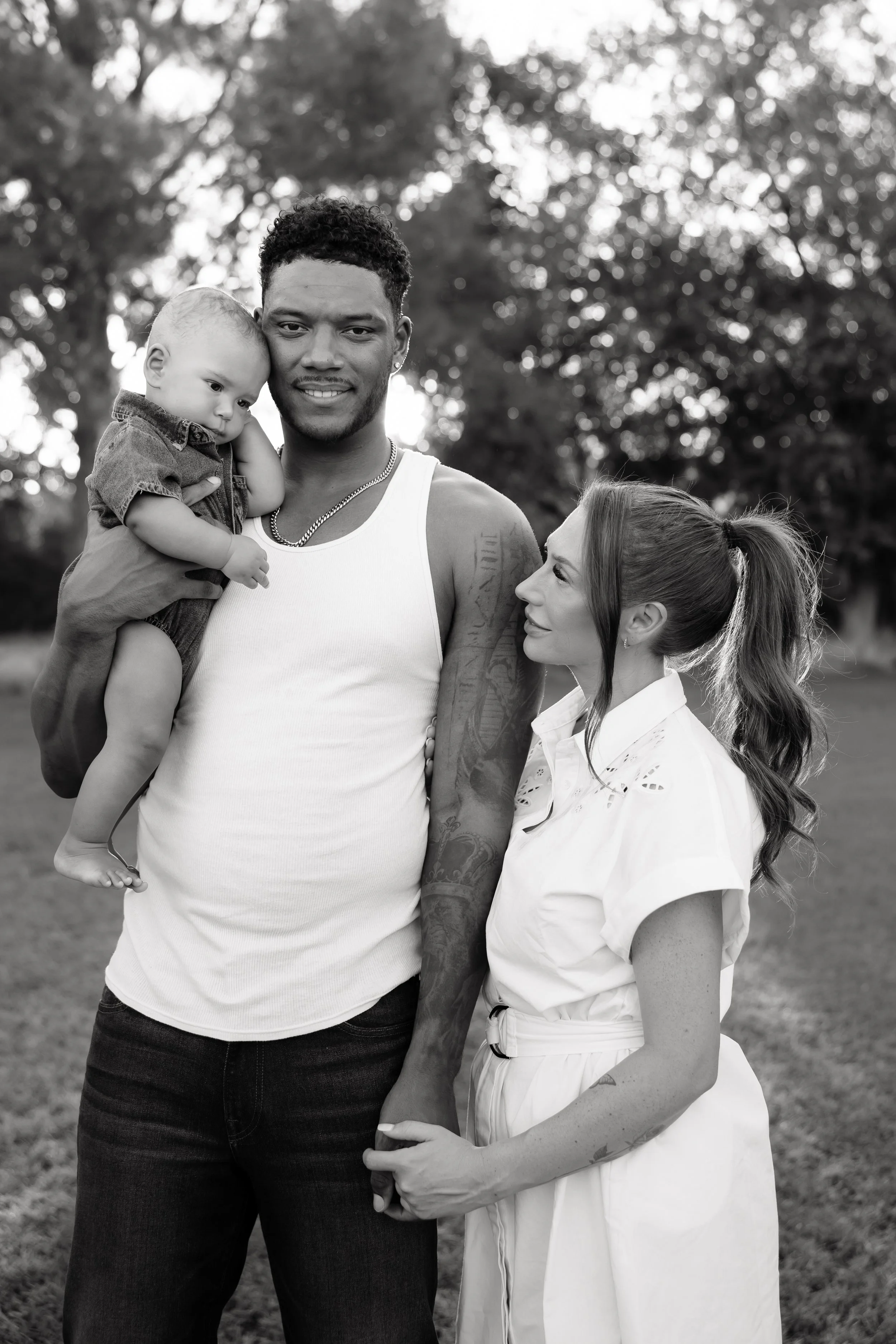 Young family embracing outdoors during a golden hour portrait session in arizona