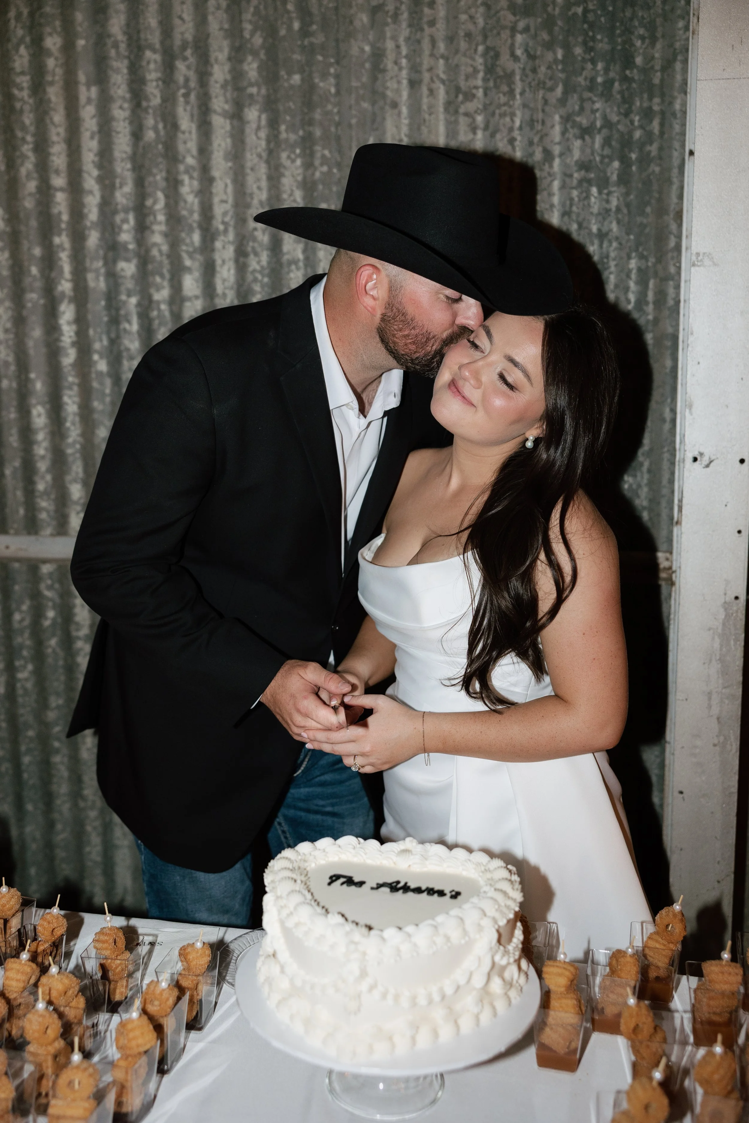bride and groom cutting wedding cake
