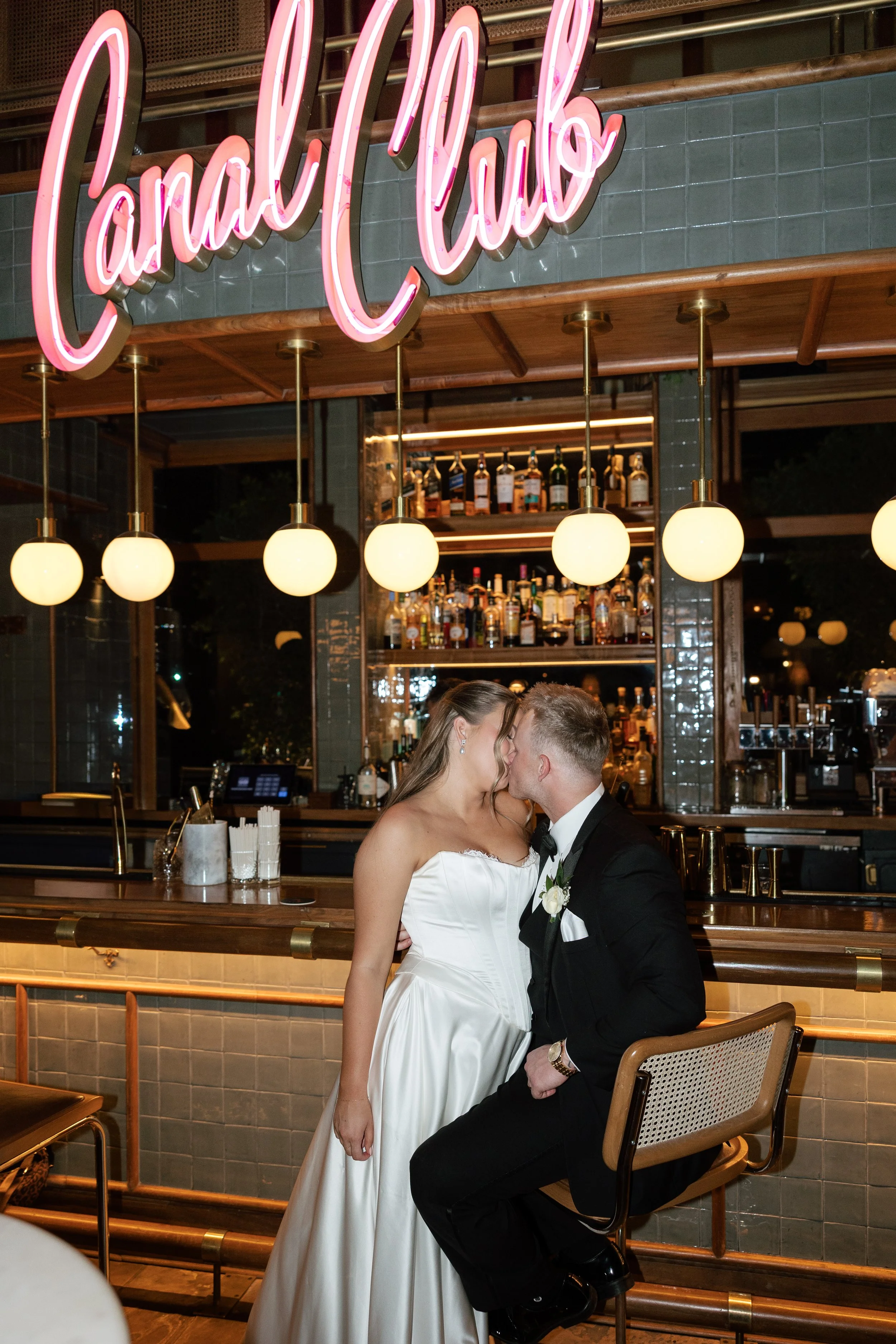 Bride and groom kissing inside The Canal Club at The Scott Resort & Spa in Scottsdale, Arizona