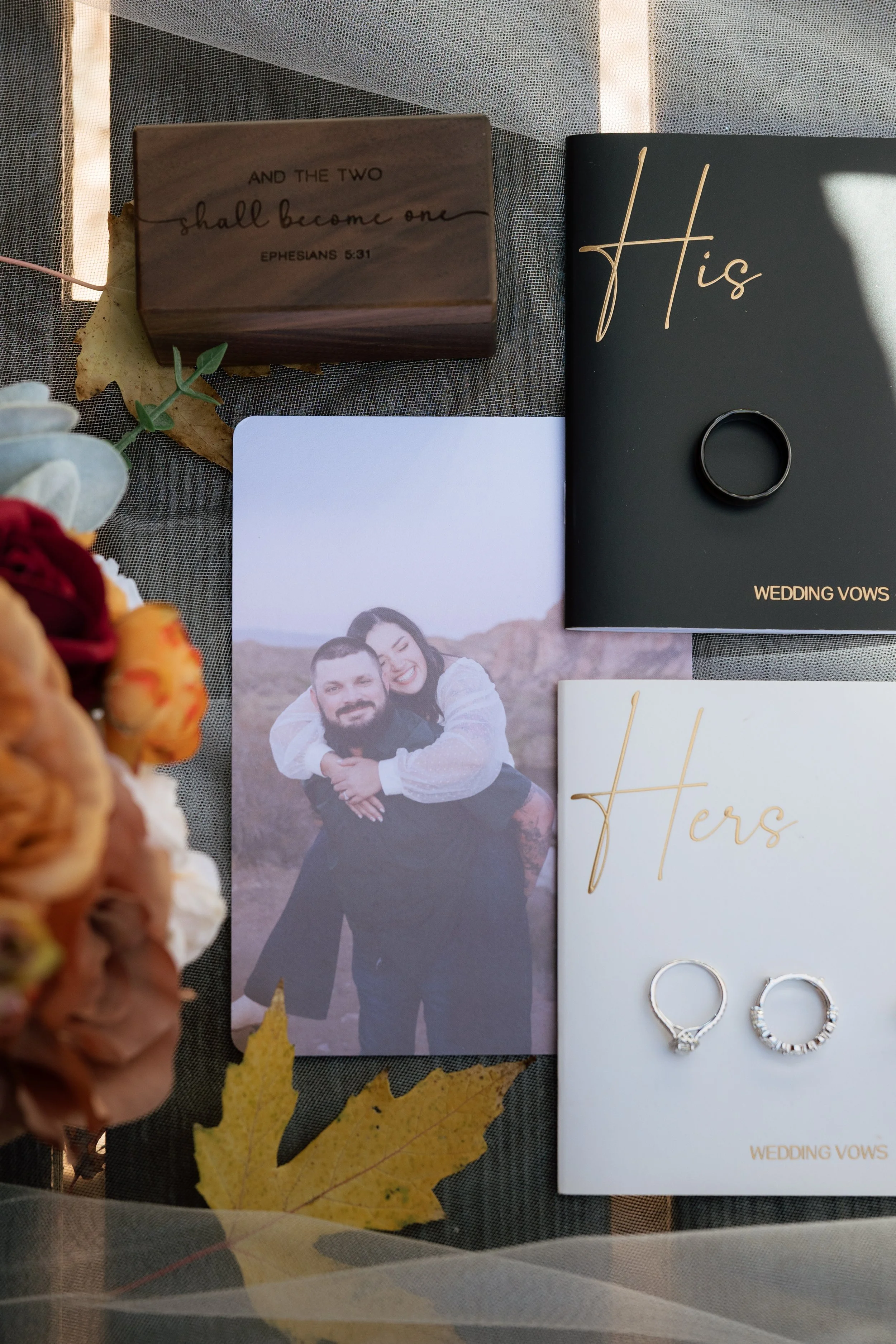 wedding day flat lay including fall leaves and bridal details