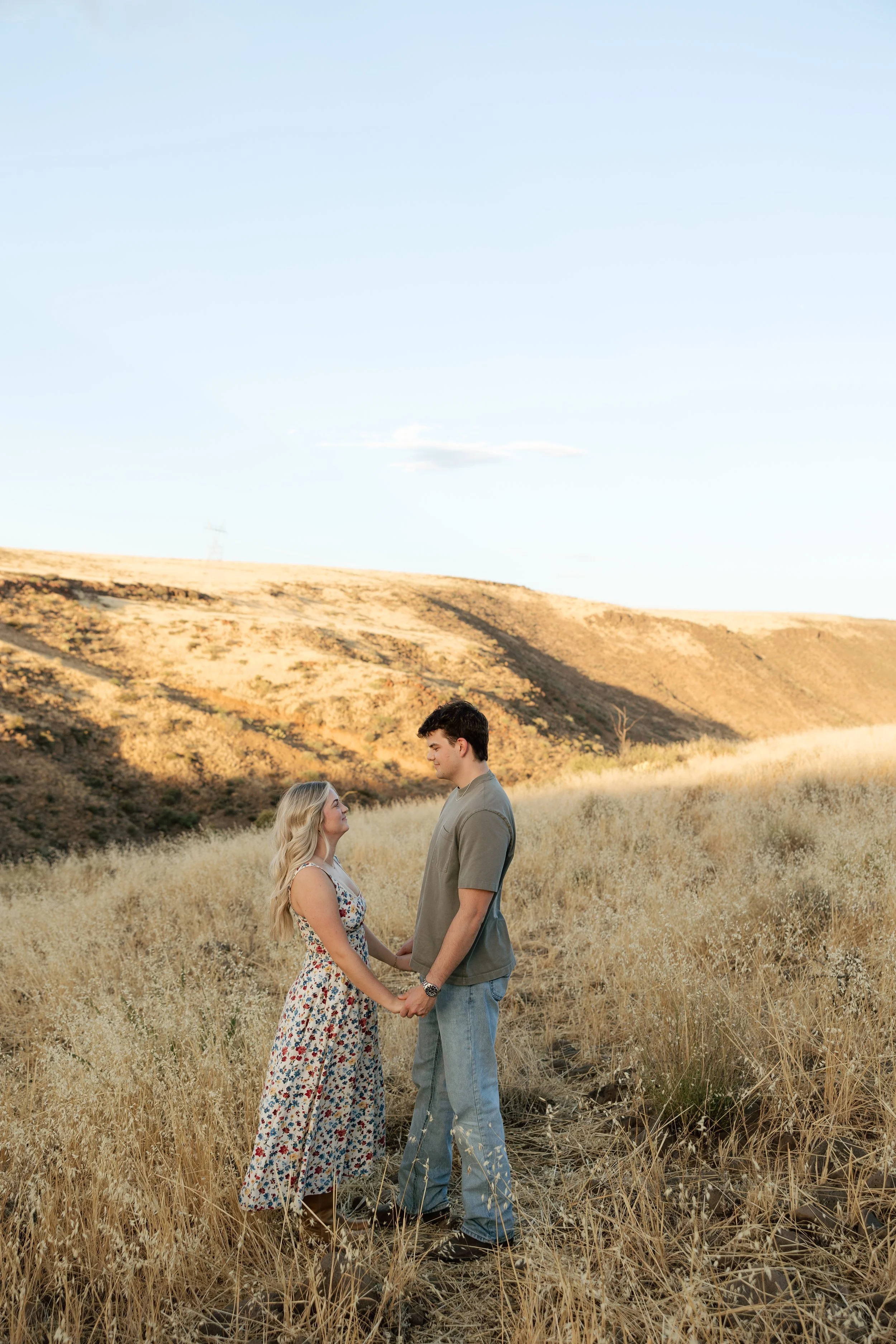 Engaged couple holding hands during a natural outdoor portrait session in Arizona